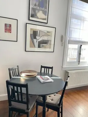 a dining room with a table and two chairs at Holiday Home Amélie in Antwerp