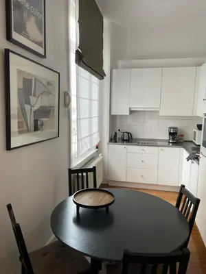 a kitchen with a table and chairs and a table and a table and a kitchen at Holiday Home Amélie in Antwerp