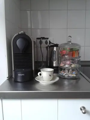 a counter top with a coffee cup and a toaster at Holiday Home Amélie in Antwerp