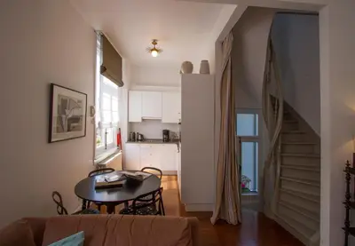 a living room with a table and a kitchen at Holiday Home Amélie in Antwerp