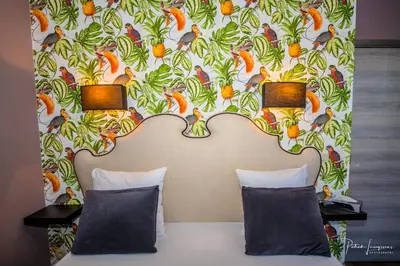a bed with two pillows in a room with a wall at Dock 29 in Antwerp