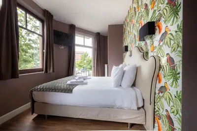 a bedroom with a bed with a colorful wall at Dock 29 in Antwerp