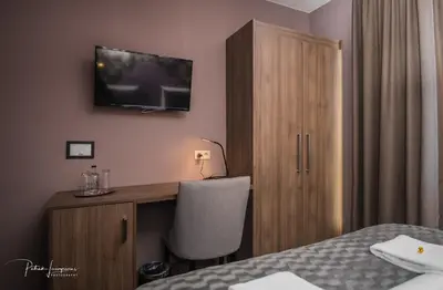 a hotel room with a bed and a desk with a television at Dock 29 in Antwerp