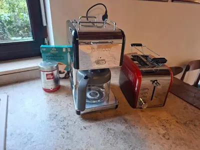 a coffee maker sitting on a counter next to a box at De Wijngaard in Ghent