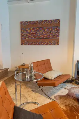 a living room with a couch and a glass table at De Wijngaard in Ghent