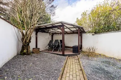 a pavilion with a table and chairs on a patio at Magnolia Green Garden New and fully equipped in Brussels