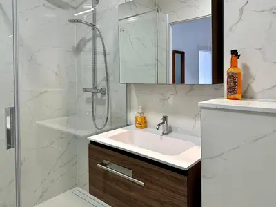 a bathroom with a sink and a shower at Stay in Artist’s Gallery in Antwerp