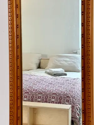 a mirror reflection of a bed in a bedroom at Stay in Artist’s Gallery in Antwerp