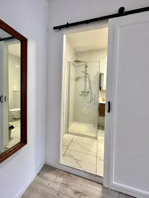 a bathroom with a shower and a mirror at Stay in Artist’s Gallery in Antwerp