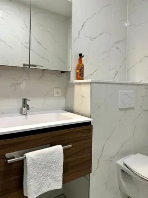 a white bathroom with a sink and a toilet at Stay in Artist’s Gallery in Antwerp