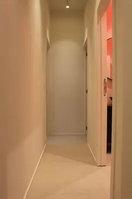 an empty hallway with an open door in a room at The View in Antwerp