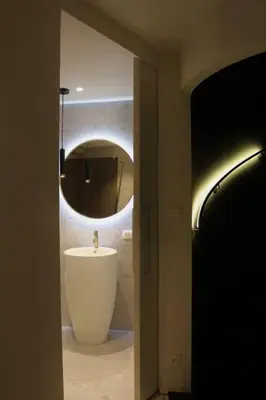 a bathroom with a white sink and a mirror at The View in Antwerp
