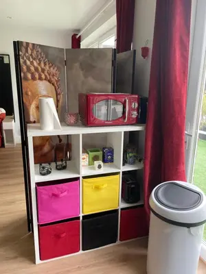 a shelf with different colored drawers and a microwave at Flat vane & Soun in Waterloo