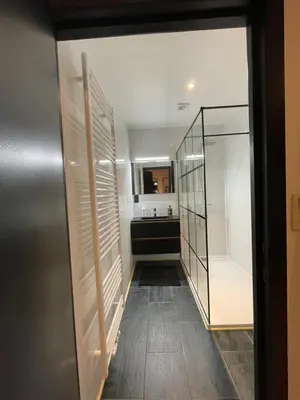 a hallway with a glass door leading to a kitchen at Flat vane & Soun in Waterloo