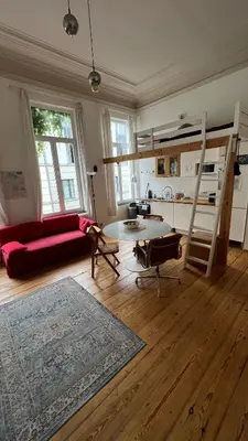 a living room with a red couch and a loft bed at Arti Appart Louise/Flagey/Centre in Brussels