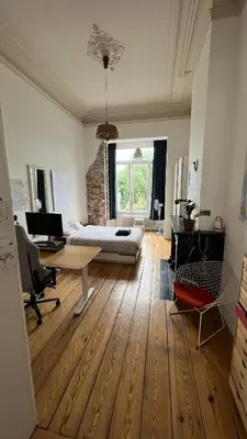 a living room with a table and a couch at Arti Appart Louise/Flagey/Centre in Brussels