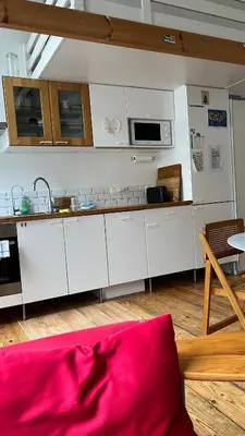 a kitchen with white cabinets and a microwave at Arti Appart Louise/Flagey/Centre in Brussels