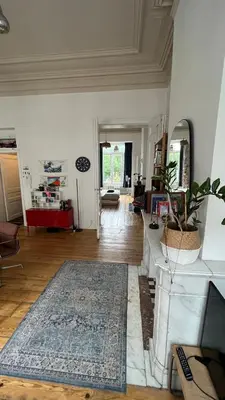 a living room with a table and a rug at Arti Appart Louise/Flagey/Centre in Brussels
