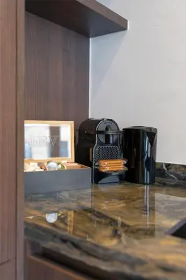 a counter with a coffee maker and a box on it at Classy 1BR Apartment Overlooking a Beautiful Park in Antwerp