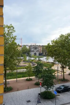 a view of a park with trees and buildings at Classy 1BR Apartment Overlooking a Beautiful Park in Antwerp