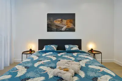 a bedroom with a bed with two stuffed animals on it at Classy 1BR Apartment Overlooking a Beautiful Park in Antwerp