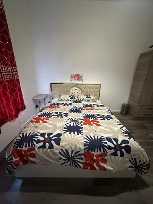 a bedroom with a bed with a quilt on it at Modern & Comfortable City Center Oasis~King Bed ! in Brussels