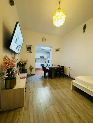 a living room with a table and a dining room at Modern & Comfortable City Center Oasis~King Bed ! in Brussels