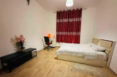 a bedroom with a bed and a red curtain at Modern & Comfortable City Center Oasis~King Bed ! in Brussels