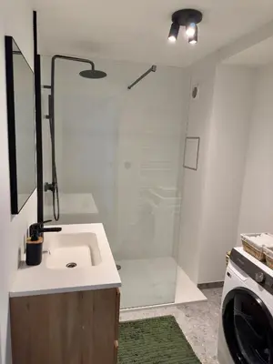 a white bathroom with a sink and a shower at Cosy apartment in Ghent in Ghent