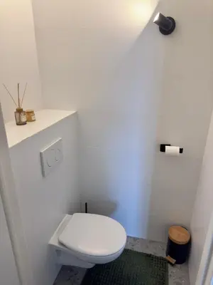 a bathroom with a white toilet in a room at Cosy apartment in Ghent in Ghent