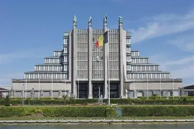a large building with a flag in front of it at Jungle Magic Room near Atomium , Heyzel Stadium in Strombeek-Bever