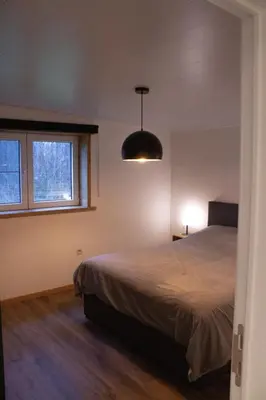 a bedroom with a bed and a window at Vakantiewoning 't Bruggeneindje in Heist-op-den-Berg