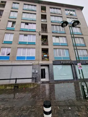 a tall building with a street light in front of it at Central home in Brussels