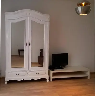 a white cabinet with a tv in a room at Almost White, Near Train, Metro n7688 in Brussels