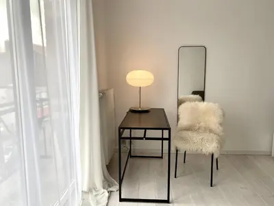 a mirror and a table with a chair and a lamp at Wit II, Near Metro, Train n7670 in Brussels