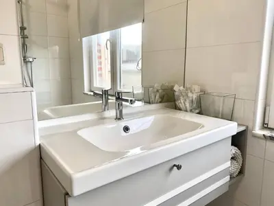 a white bathroom with a sink and a mirror at Wit II, Near Metro, Train n7670 in Brussels