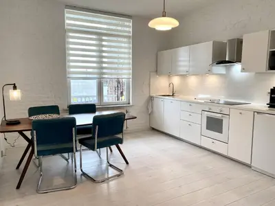 a kitchen with a table and chairs in a room at Wit II, Near Metro, Train n7670 in Brussels
