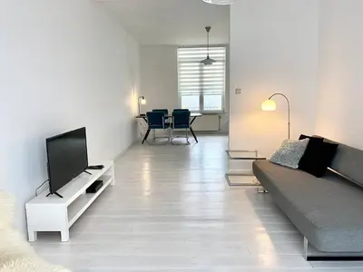 a living room with a couch and a flat screen tv at Wit II, Near Metro, Train n7670 in Brussels