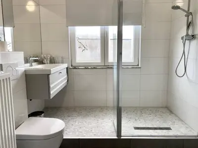 a bathroom with a shower and a toilet and a sink at Wit II, Near Metro, Train n7670 in Brussels