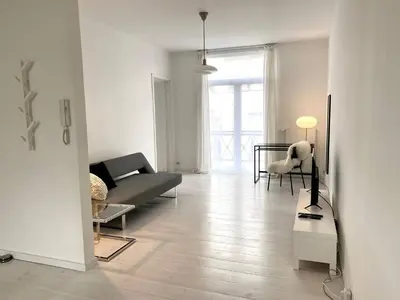 a living room with a couch and a table at Wit II, Near Metro, Train n7670 in Brussels