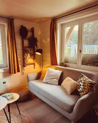 a living room with a couch and a window at Chalet Chalazy in Lille