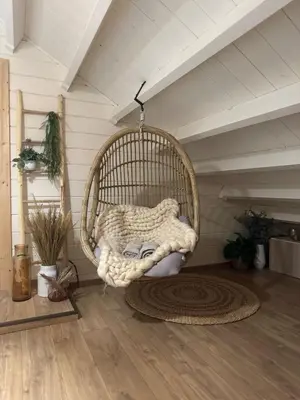 a room with a rattan chair in a attic at Chalet Chalazy in Lille