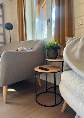 a living room with a couch and two tables at Chalet Chalazy in Lille