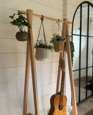 a guitar leaning against a wall with potted plants at Chalet Chalazy in Lille