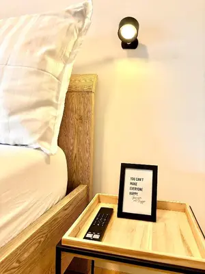a tray with a laptop on a table next to a bed at Il Casolare in Beersel