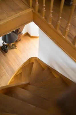 an overhead view of a wooden spiral stairway at Chic Penthouse Grand-Place in Brussels