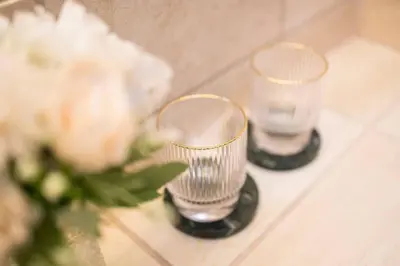 a couple of glasses sitting on a shelf with flowers at Chic Penthouse Grand-Place in Brussels