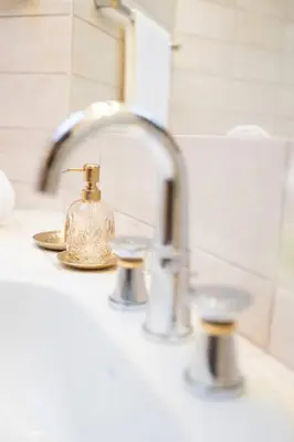 a bathroom sink with a soap dispenser on it at Chic Penthouse Grand-Place in Brussels