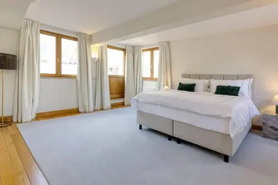 a large bedroom with a white bed and windows at Unique Flat on the GRAND PLACE in Brussels