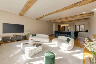 a living room with two white couches and a flat screen tv at Unique Flat on the GRAND PLACE in Brussels